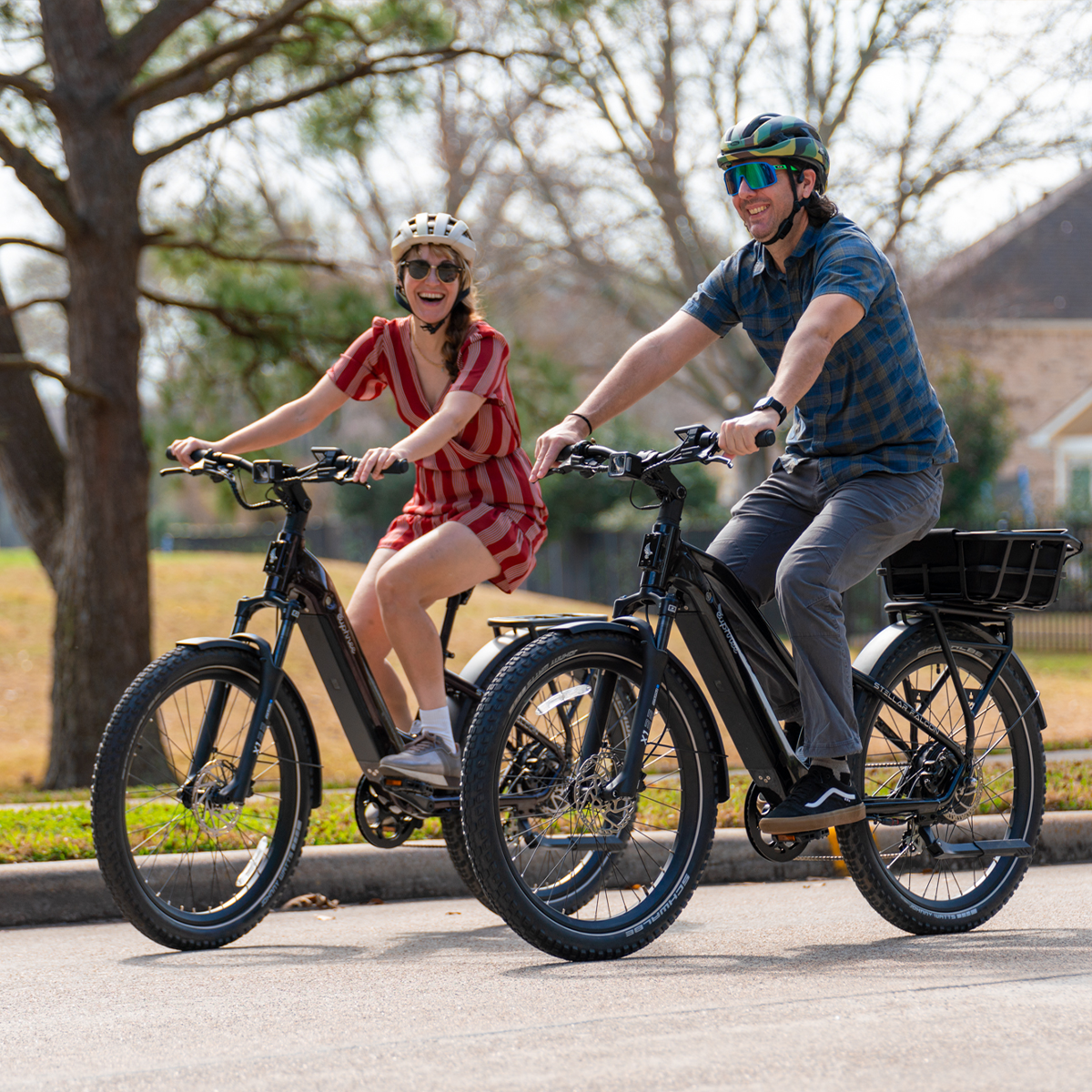 Couple riding Stellar Falcon Step-Thru in Black Cherry and Mid-Step in Galaxy Blue through the park